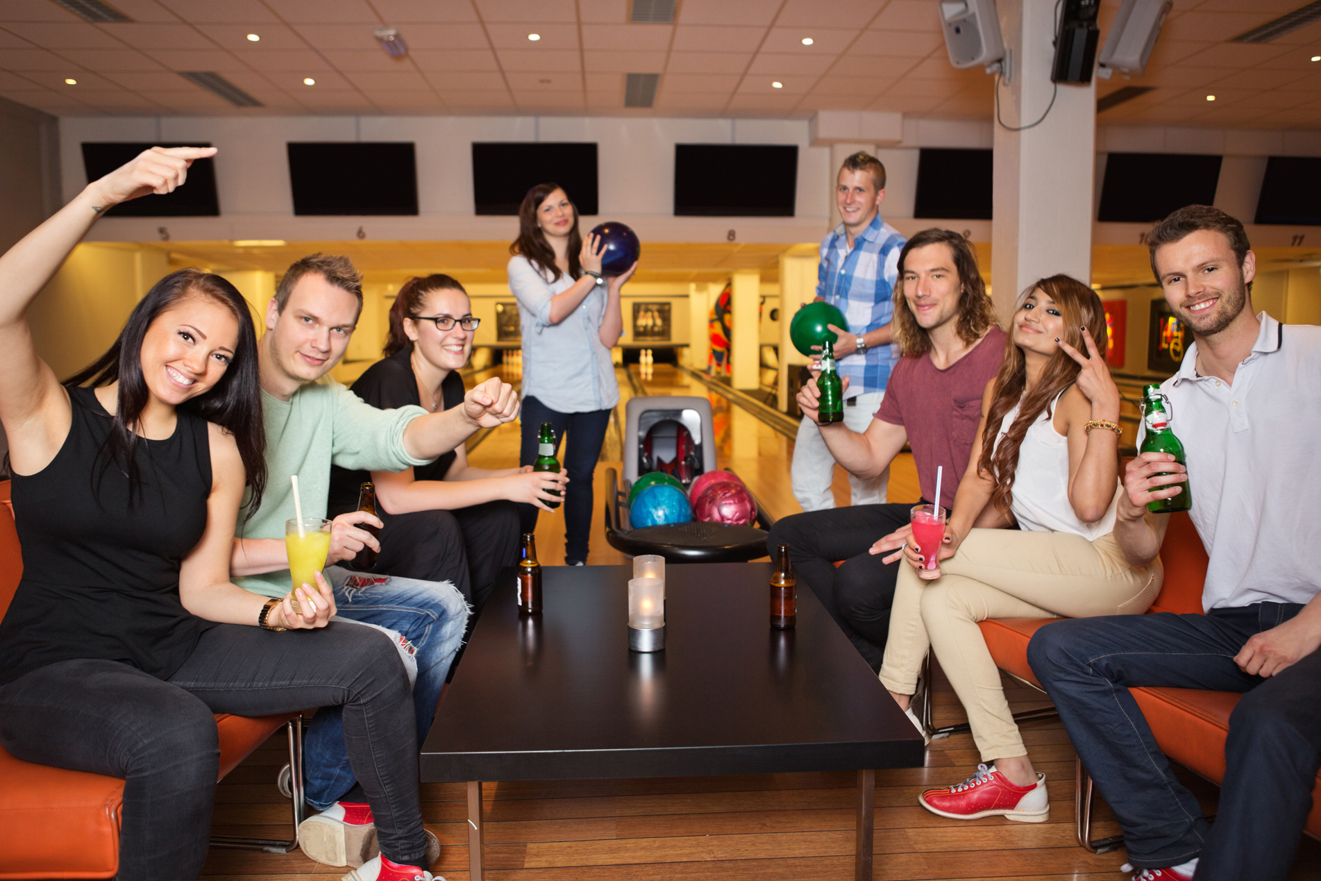 Image of people holding drinks and smiling