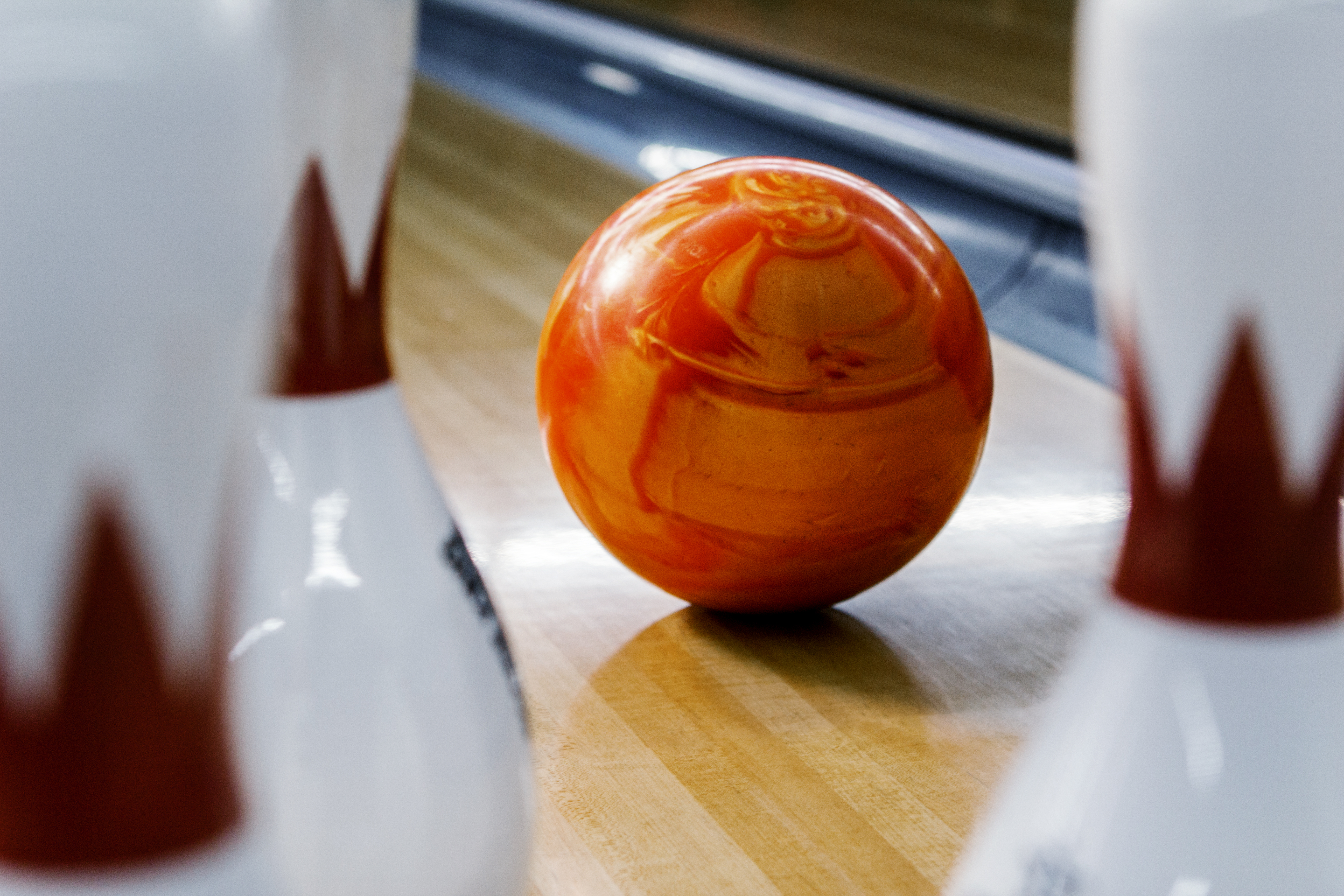 Bowling ball heading towards pins